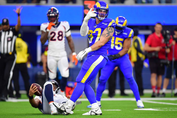 Dec 25, 2022; Inglewood, California, USA; Los Angeles Rams defensive tackle Michael Hoecht (97) reacts after sacking Denver Broncos quarterback Russell Wilson (3) during the second half at SoFi Stadium. Mandatory Credit: Gary A. Vasquez-USA TODAY Sports